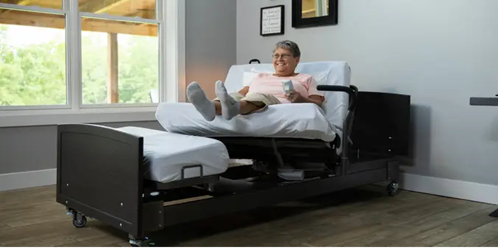 Caregiver safely turning a patient to prevent pressure sores and improve comfort